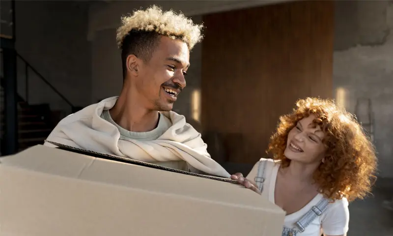 a man and woman holding a box